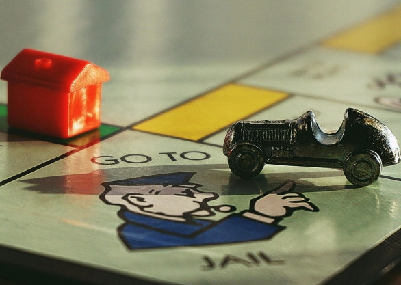 Monopoly Afternoon Tea London bus, themed Monopoly bus tour, London sightseeing bus interior, Monopoly cocktail on board, gourmet afternoon tea spread, interactive Monopoly games onboard, London landmarks through bus windows, celebratory party on Monopoly bus, double-decker bus tour London, Monopoly themed entertainment on bus
